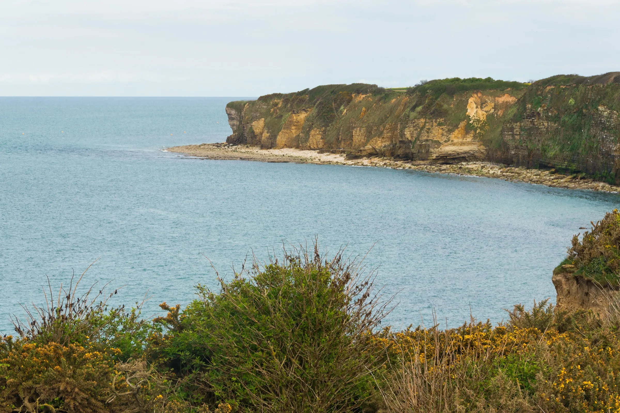Les falaises escarpées de la Pointe du Hoc surplombant la Manche, vues depuis le sommet du promontoire